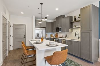 Shaker-style gray cabinetry with gold hardware (b)